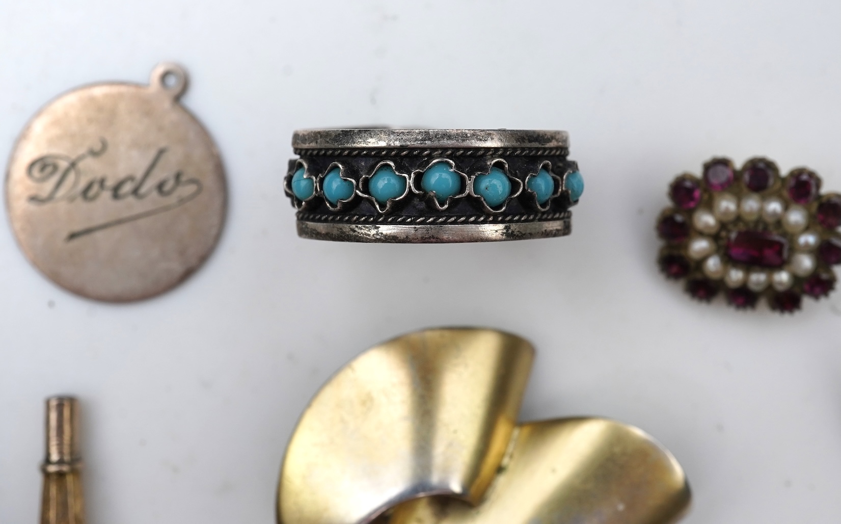 A small group of assorted collectables and jewellery including a Dunhill lighter, 64mm, a George V silver and enamel small compact, silver thimble, two Victorian garnet set brooches, an Edwardian 9ct, amethyst and seed p